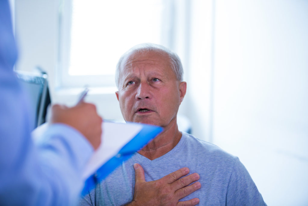 Elderly male patient discussing treatment options with his doctor.